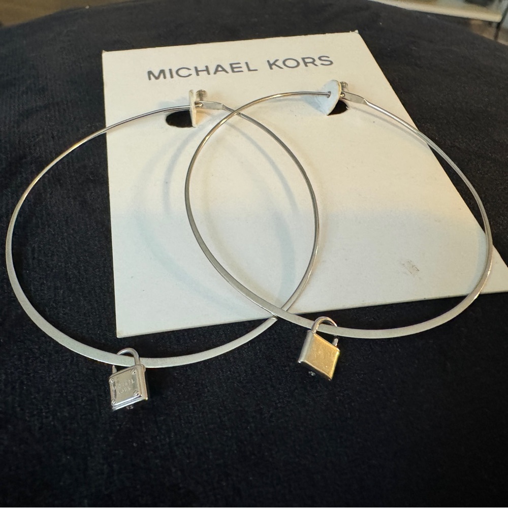 Michael Kors silver hoop earrings with branded locket charm